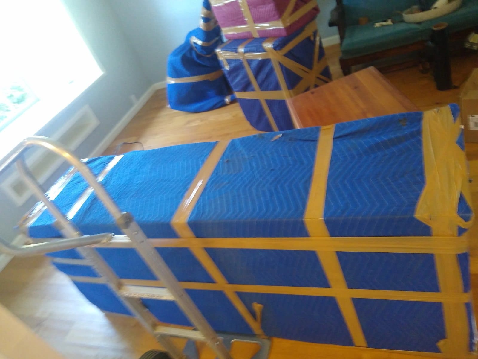 Blue and gold wrapped gift boxes with ribbon on wooden floor indoors