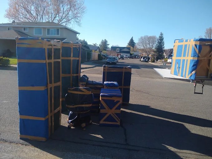 Blue and brown wooden storage structures displayed in a residential driveway
